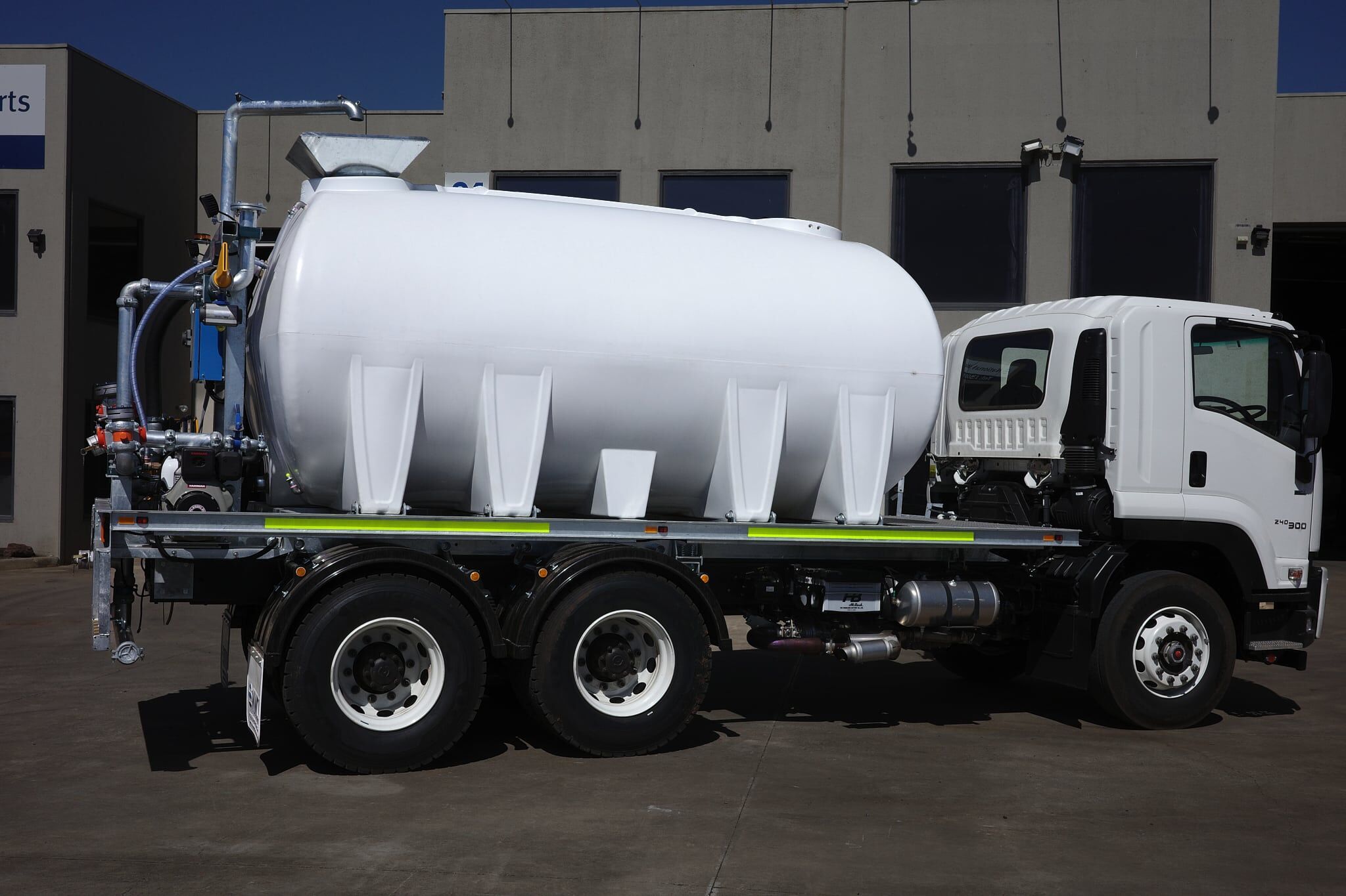 Side profile of a CivMaster EXM FVZ diesel water truck parked at the National Water Carts facility in Ravenhall, Victoria.