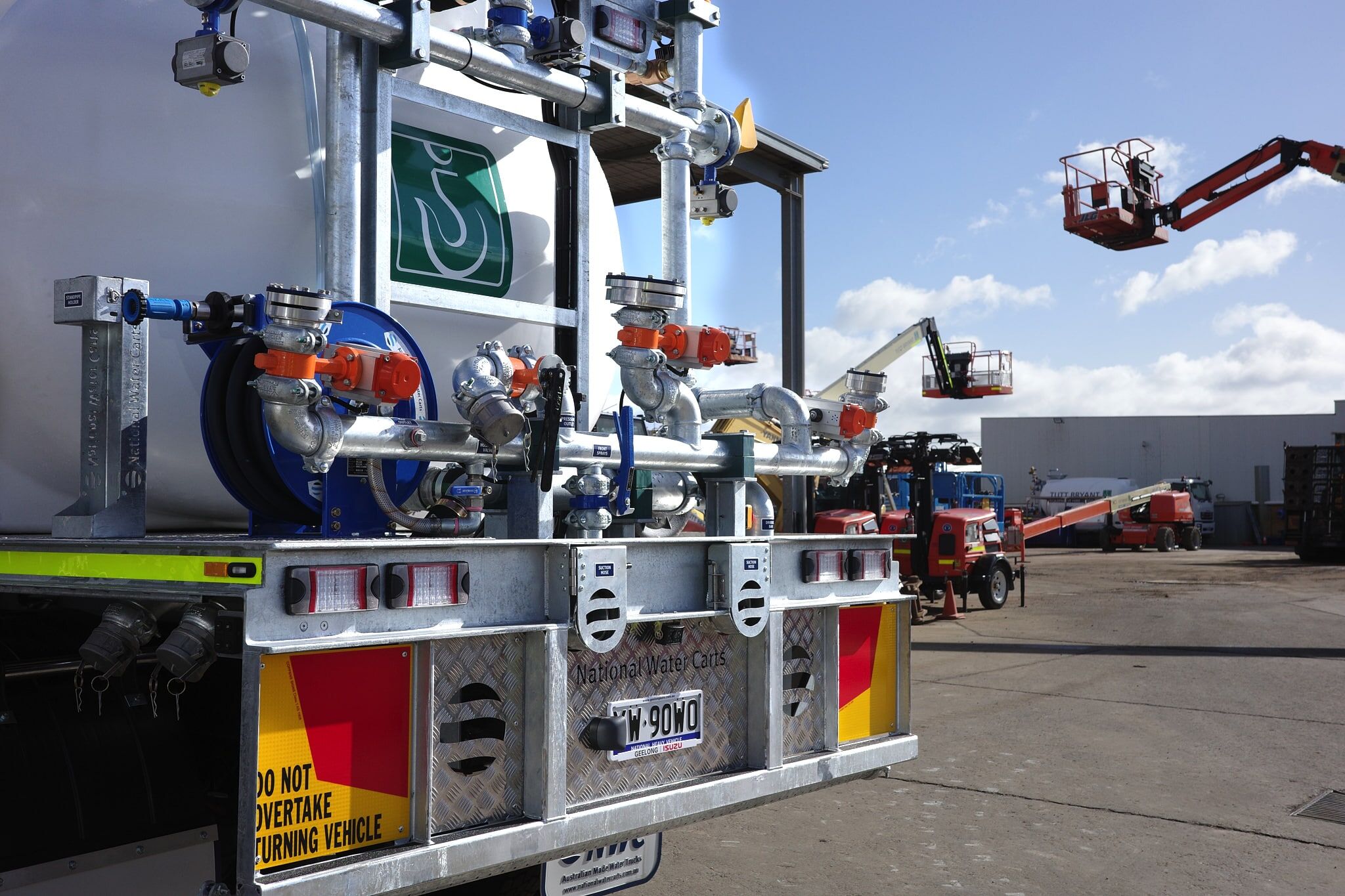 A close-up of the CivMaster EXM FVZ hydraulic spray system manifold at the Tutt Bryant facility in Moolap, with plant equipment in the background.